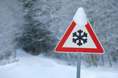 Close-up of warning sign on snow