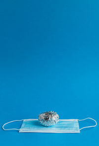 High angle view of ice cream on table against blue background