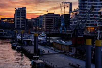 High angle view of river amidst buildings in city at sunset