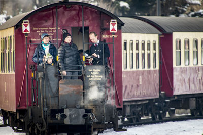 People on train at railroad station