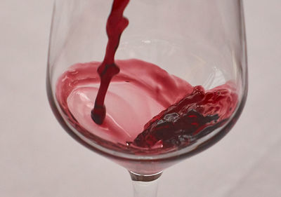 Close-up of red wine being poured into glass
