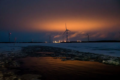 Distance shot of wind turbines at frozen sea