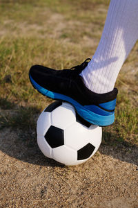 Low section of person playing soccer