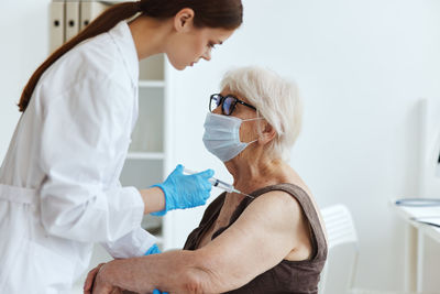 Midsection of woman wearing mask