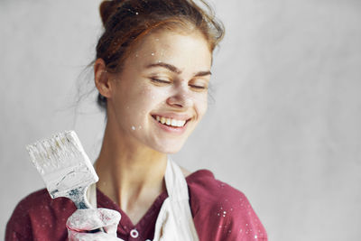 Portrait of young woman drinking water