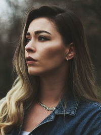 Close-up of beautiful young woman looking away