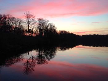 Scenic view of calm lake at sunset