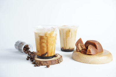 Close-up of coffee cup on table against white background