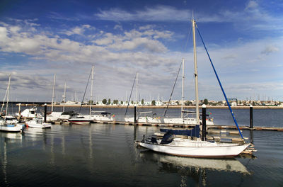 Boats sailing in sea against sky