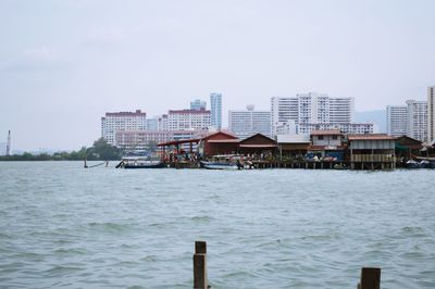 View of built structure by sea