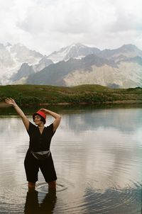 Rear view of woman standing in lake