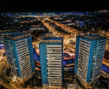 High angle view of illuminated buildings in city at night