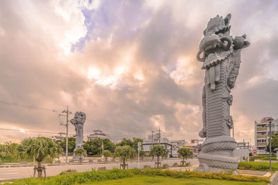 Statue of building against cloudy sky