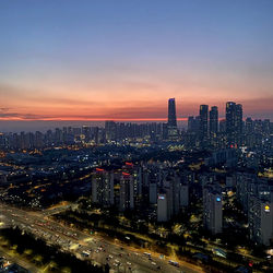 Aerial view of cityscape against sky during sunset