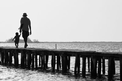 Father and son walking on jetty