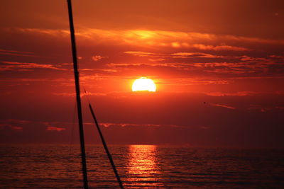 Scenic view of sea against orange sky