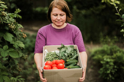 Woman holding vegetables in basket