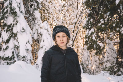 Portrait of teenage girl standing in snow