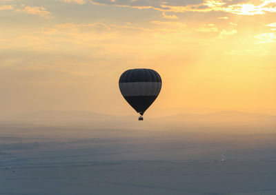 Hot air balloon flying in sky during sunset