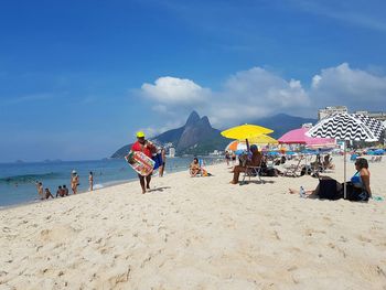 People on beach against sky