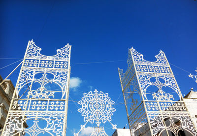 Low angle view of cross against blue sky