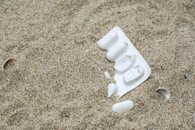 High angle view of coffee on sand