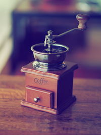 Close-up of coffee maker on wooden table