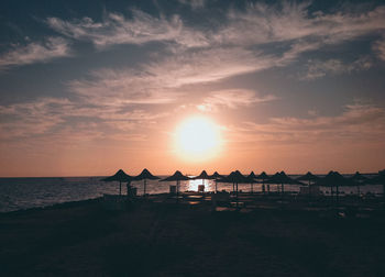 Scenic view of beach against sky during sunset