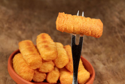 Close-up of fork with food on table