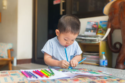 Boy drawing on table at home