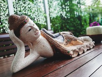 Close-up of buddha sculpture on table