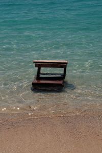 Empty bench on sea shore