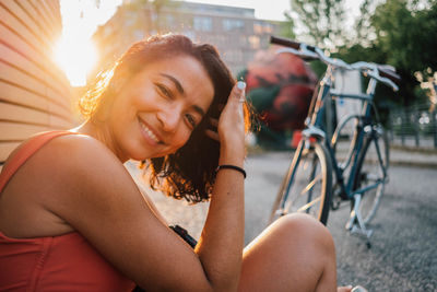 Close-up portrait of smiling woman sitting outdoors