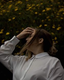 Portrait of woman standing against plants