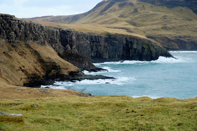 Scenic view of sea and mountains against sky