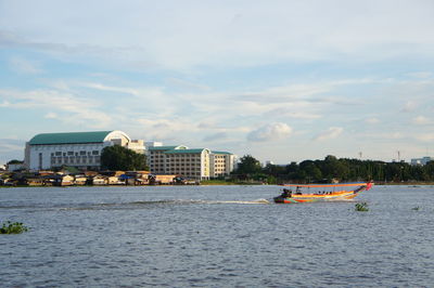 Scenic view of river against buildings in city