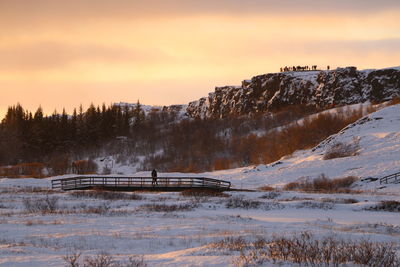 Scenic view of snow covered mountains against sky during sunset