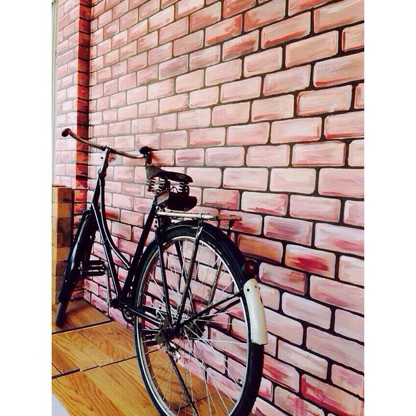 bicycle, architecture, built structure, building exterior, brick wall, transportation, wall - building feature, stationary, parked, mode of transport, land vehicle, red, wall, parking, day, wheel, no people, outdoors, auto post production filter, leaning