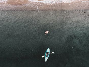 Aerial view of woman kayaking in sea