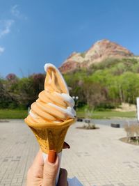 Hand holding ice cream cone