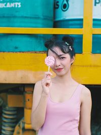 Portrait of woman holding lollipop