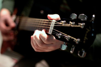 Close-up of man playing guitar