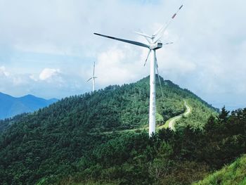 Low angle view of windmill against sky