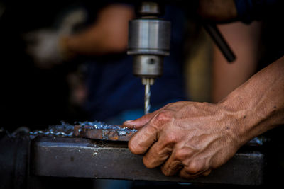 Close-up of manual worker working in factory