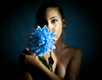 Portrait of a beautiful young woman over black background