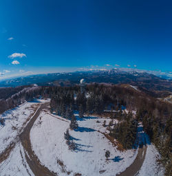 Scenic view of snowcapped mountains against blue sky