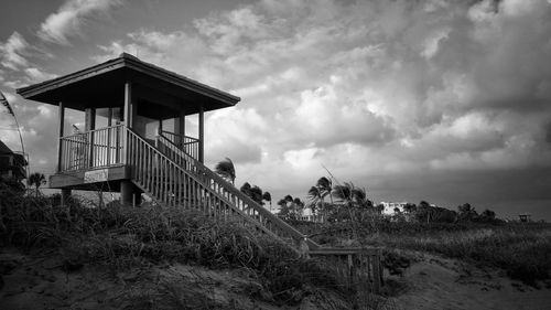 Lifeguard hut on field against sky