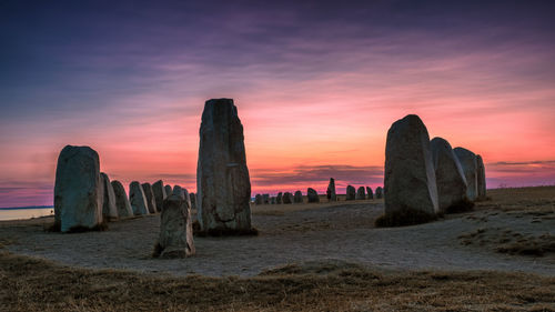 Scenic view of sea against romantic sky at sunset  - this is ale stenar at sunset