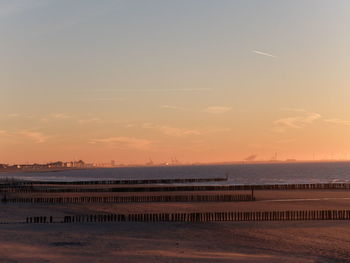 Scenic view of beach against sky during sunset