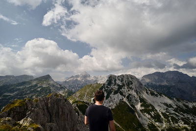 Distant view of man standing on cliff